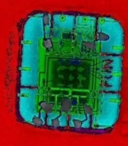 An artificially colored x-ray image showing the FUN chip and the green stolen credit card chip soldered to it.